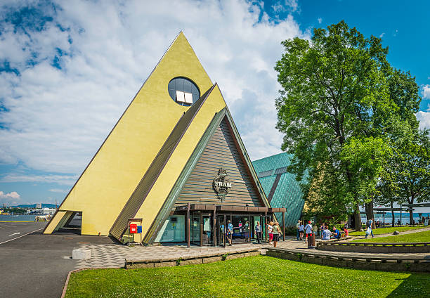 Oslo, Norway - 11th July 2014: Tourists visiting the famous pyramid of the Fram Museum of polar exploration on the Bygdoy peninsula of Oslo, Norway. Composite panoramic image created from five contemporaneous sequential photographs.