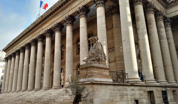The classic buuilding with columns now the Bourse with French flag flying in the Marais district Paris France
