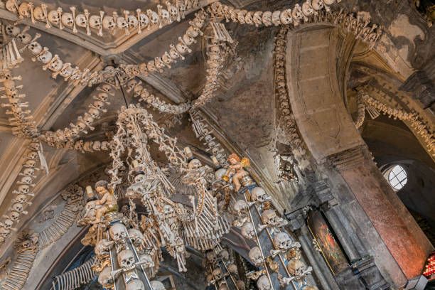 Prague, Czech Republic - Sept 04, 2019: Arranged Human Skulls and Bones in Kostnice Church in Kutna Hora, Czech Republic. Ossuary decoration of human bones and skulls