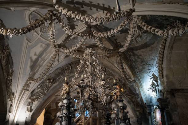 Kutna Hora, Czech Republic - November 11, 2018: Ceiling at Cemetery Church of All Saints "ornamented" with Human bones and skulls in the Ossuary at Kutna Hora, Czechia