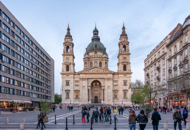 April 16, 2017 - Budapest, Hungary: Tourists in Zrinyi Utca street and St. Stephen`s Basilica in Budapest, Hungary