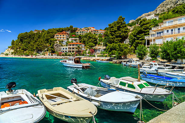 Typical mediterranean houses and fishing harbor with motorboats,Makarska riviera,Brela,Dalmatia,Croatia,Europe